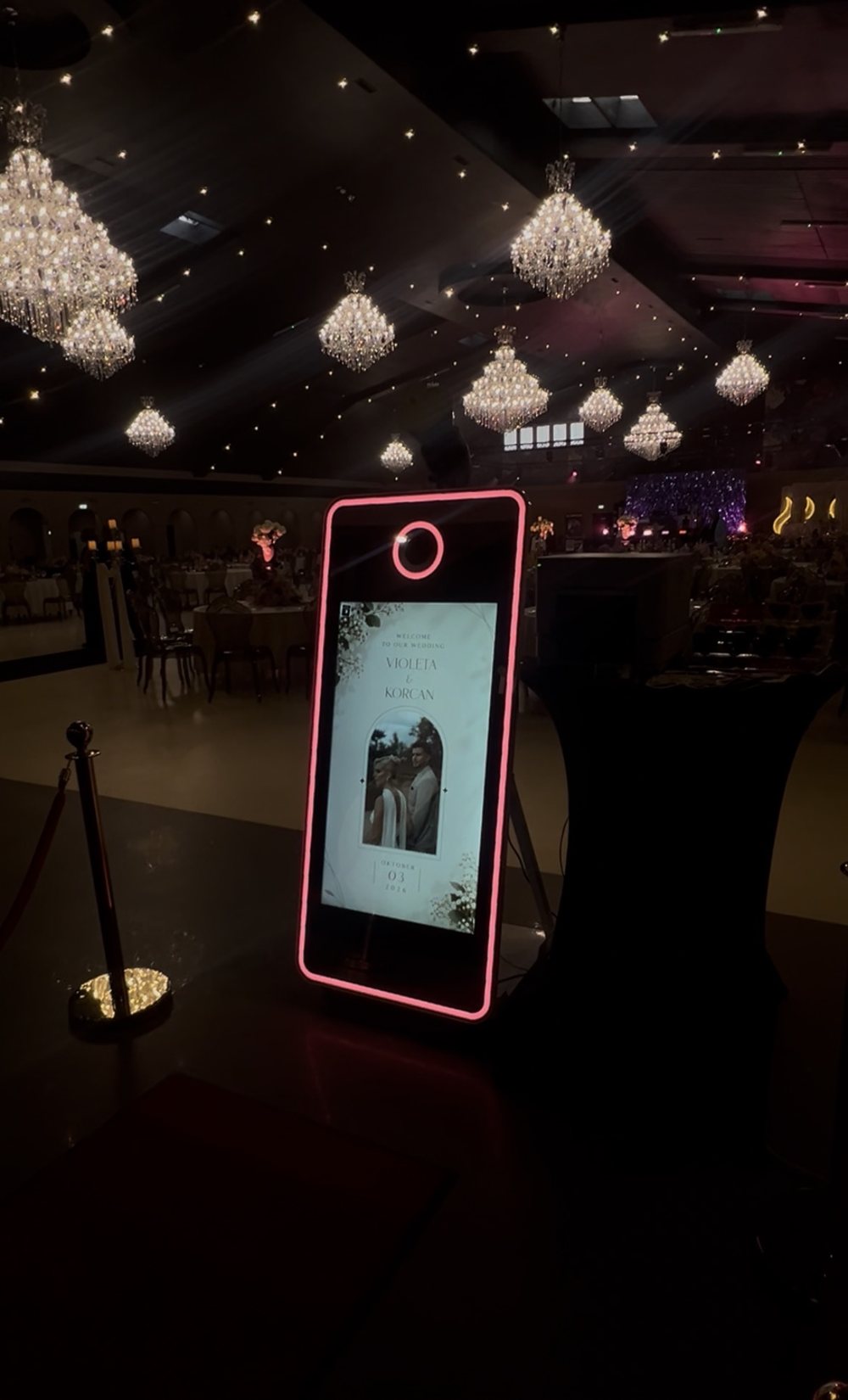 Fotospiegel mit pinkem Licht und individuellem Startbildschirm in einem Festsaal mit Kronleuchtern